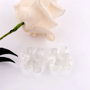 Close-up of clear resin floral charms with white rose on a clean white background