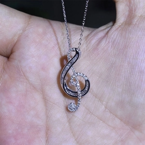 Elegant treble clef musical note pendant necklace with sparkling pavé cubic zirconia
