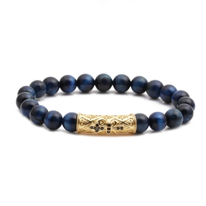 Blue tiger eye beaded bracelet with golden hollow cross tube and black crystals on white background