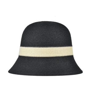 Detail of black woven bucket hat with contrast beige ribbon and fine straw texture