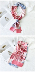 Detail view of pink and blue silk scarf showing artistic pattern and knotted styling