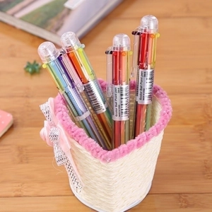 Minimalist 6-color transparent ballpoint pens set in a decorative desktop holder