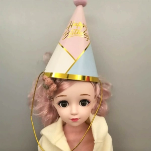 Detail of party hat with colorful patterns, gold Happy Birthday text and pink pom-pom