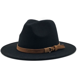 Detail of black fedora hat featuring a brown suede band and gold circular buckle