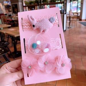 Detailed view of 3-piece pink baby headband set with lace, tulle flowers and rabbit ears