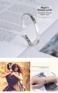 Close-up of a silver minimalist hammered cuff bracelet with unique crater texture for women