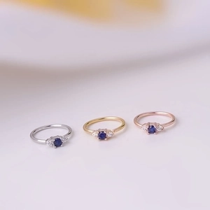 Nose rings in silver, gold, and rose gold with blue zircon stones for body piercing
