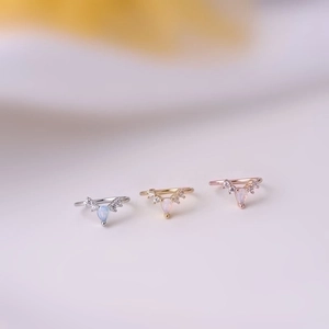 Three-piece V-shaped nose rings in silver, gold, and rose gold with teardrop opal stone