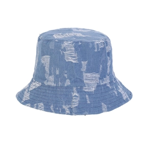 Close-up of distressed light blue denim bucket hat with ripped details and fringe