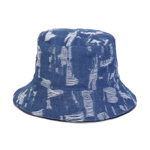 Breathable blue denim bucket hat with distressed white frayed details on white background