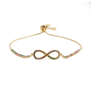 Detail of adjustable gold infinity bracelet with colorful inlaid cubic zirconia stones