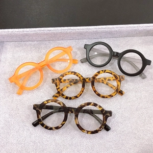 Flat lay of colorful round children's frames in orange, black and leopard patterns