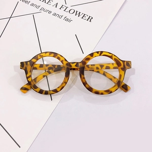 Detailed view of round tortoiseshell glasses frames on a minimalist background