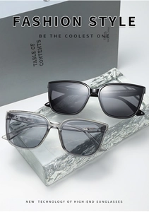 Detailed view of square thick frame sunglasses in black and translucent grey colors