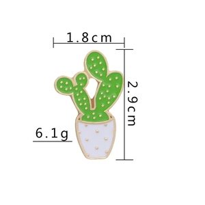 Detail of cartoon cactus enamel pin showing size 1.8cm by 2.9cm and 6.1g weight