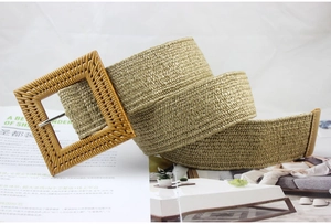 Close-up of bohemian woven straw belt featuring a large square buckle and intricate texture