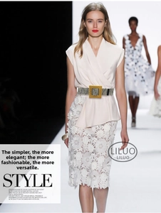 Close-up of woven stretch belt featuring a gold square buckle on a stylish dress