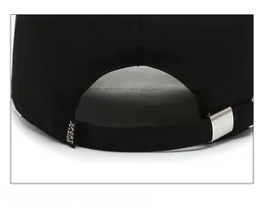 Detail view of adjustable silver metal buckle and sport tag on black quick-dry cap