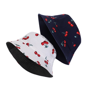 Double-sided cotton bucket hat featuring cherry prints in white and navy blue colors