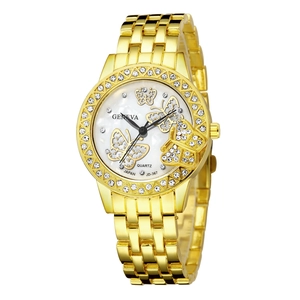 Close-up of Geneva gold watch featuring butterfly patterns and diamond-set bezel