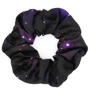 Macro shot of purple and black star pattern fabric scrunchie with soft textile texture