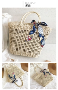 Detail of beige hollow mesh woven straw bag with floral silk scarf on round handle