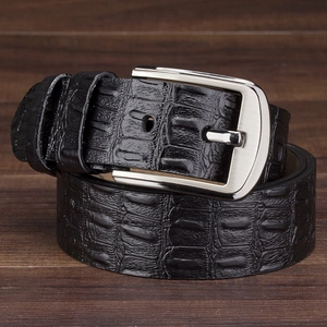 Men's black alligator grain leather belt with silver pin buckle on wooden background
