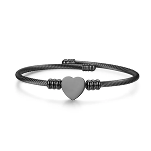 Black twisted cable stainless steel bangle featuring a polished heart centerpiece