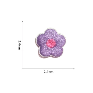 Detail of purple embroidered flower patch with dimensions 2.0cm x 2.0cm for DIY sewing