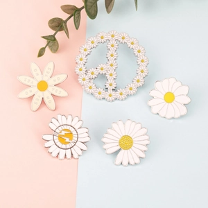 Set of five enamel daisy brooches featuring peace sign and daisy patterns on a colorful background