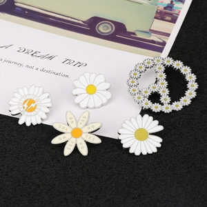 Set of 5 enamel daisy brooches including peace signs and graphic floral pins