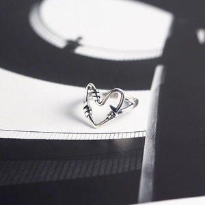 Macro shot of 925 sterling silver ring featuring a unique wire-wrapped heart design