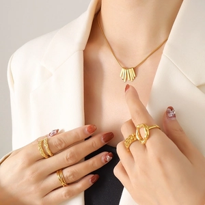 Minimalist gold plated necklace and rings set featuring geometric cube and lava texture