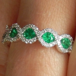 Luxurious silver wave ring with emerald green zircon stones and micro-pave white diamonds