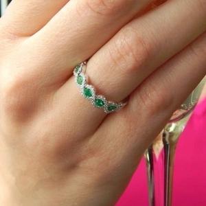 Luxurious silver emerald ring with marquise-cut green stones and micro-pave crystals