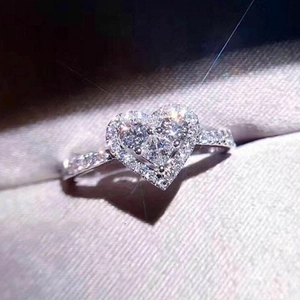 Sparkling silver heart-shaped zircon ring with pavé setting in a gray jewelry box