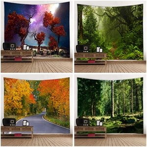 Detail showing four scenic forest tapestries displayed on a white wall in a cozy room
