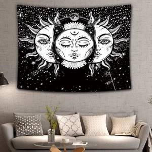 Detailed interior view of sun and moon tapestry on a textured gray wall above a sofa