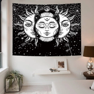 Detail showing the sun and moon celestial tapestry in a black and white bedroom setting