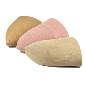 Three minimalist knit beanies in mustard, pink and beige with fine ribbed texture
