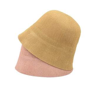 Women knit bucket hats in ginger yellow and light pink with a soft textured finish