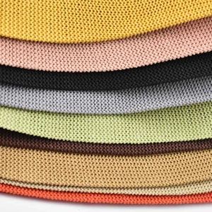 Detailed view of layered knitted fabric textures in various vibrant and neutral colors