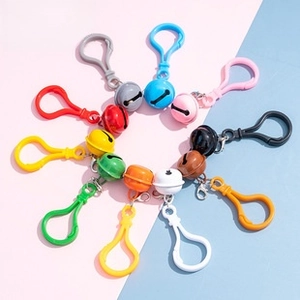 Colorful bell pendants with lobster clasps for DIY jewelry in a vibrant radial layout