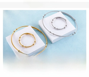 Detailed view of minimalist stainless steel wire bracelets with small ball ornaments