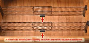Detail of adjustable transparent drawer dividers with black anti-slip pads in wood drawer
