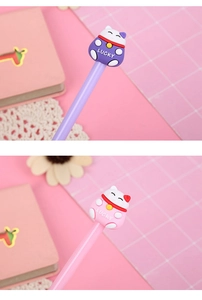 Macro shot of cute pink and purple cartoon lucky cat pen toppers with lucky lettering
