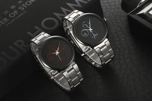 Detail of steel business watches with blue and red hands on black leather background