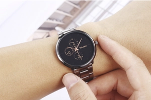 Close-up of Yolako chronograph watch with black dial and silver steel strap on wrist