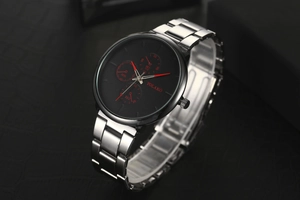 Angled view of silver stainless steel men's watch with black dial and three red hands