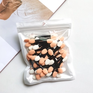 Dual-sided disposable eyeshadow sponge brushes with orange and white tips in bulk bag